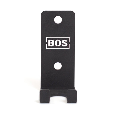 The Bells of Steel Hanging Barbell Holders are black, rectangular metal mounts labeled "BOS," featuring two mounting holes and a lower lip to securely store your barbells in your lifting gallery.