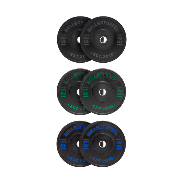 The Dead Bounce Conflict Bumper Plate Sets by Bells of Steel include six virgin rubber plates with stainless steel inserts, labeled in white, green, and blue text. The set features three pairs: 10 lb, 25 lb, and 45 lb plates.