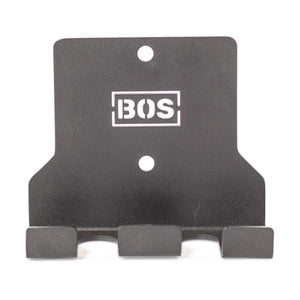 The Bells of Steel Hanging Barbell Holders are black metal wall hooks with three prongs and two mounting holes, featuring the BOS logo in white—perfect for organized storage and easy installation with compatible hardware.