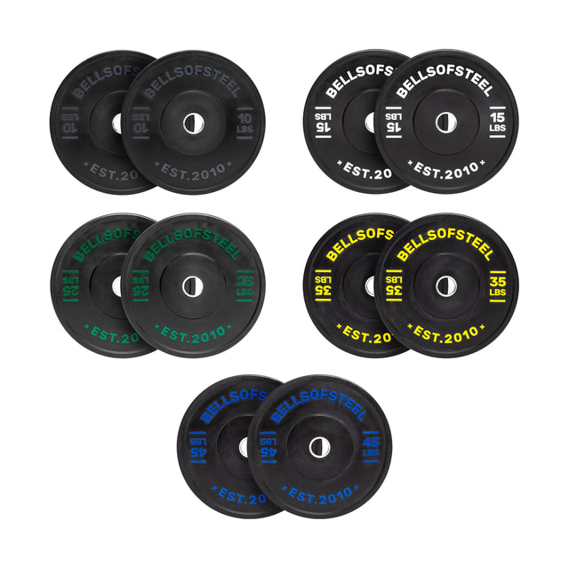 The Dead Bounce Conflict Bumper Plate Set by Bells of Steel includes eight pairs of round black plates (10, 15, 25, 35, and 45 lbs) with colored labels—all made from virgin rubber.