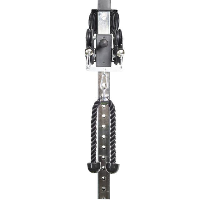 Close-up of the Bells of Steel Tricep Rope Extension, a black cable machine attachment hanging from a metal pegboard—featuring pulleys, carabiners, and a sturdy metal frame for effective strength training.