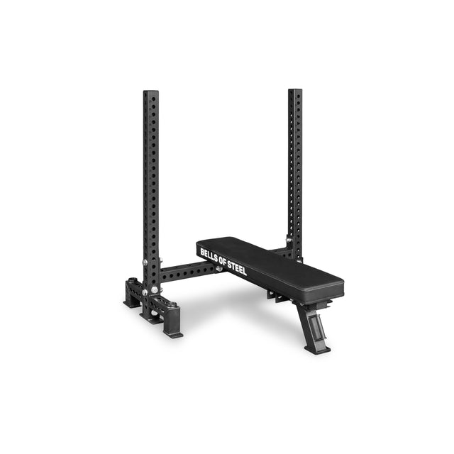The Bells of Steel Manticore Two Post Converter Bench is a black adjustable weight bench with a padded seat and sturdy two-post rack, shown against a plain white background.