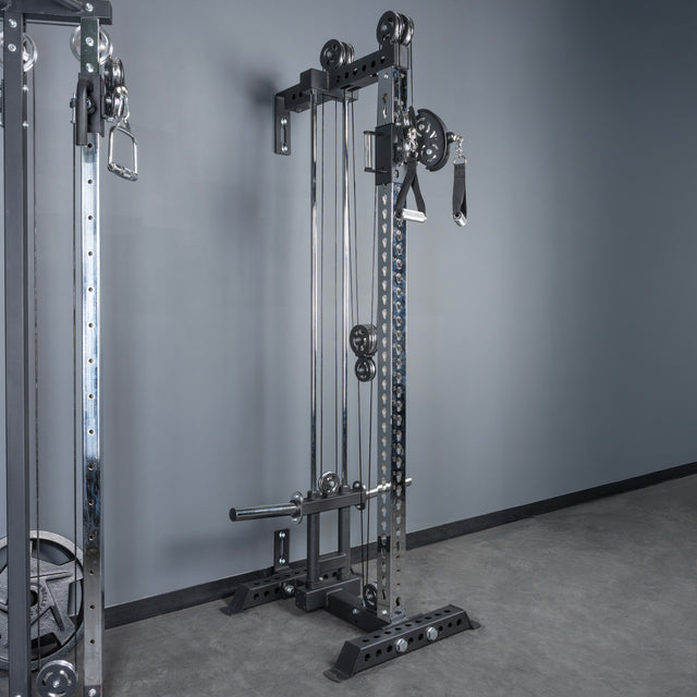The Bells of Steel Oblivyon Tower - 3" x 3” Cable Tower stands in a gym setting with adjustable weights, handles, cables, and a weight stack—ideal for versatile strength training in your home gym cable machine setup.