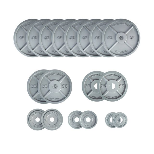 Bells of Steel Machined Iron Olympic Weight Plate Sets in gray, available in 45, 35, 25, 10, 5, and 2.5 lb sizes, feature precision holes for easy loading and are neatly arranged on a white background.