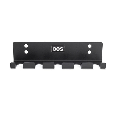 The Bells of Steel Hanging Barbell Holders is a black metal, wall-mounted rack with five hooks and four screw holes, featuring the BOS logo in white at the top—ideal for organizing your barbells.
