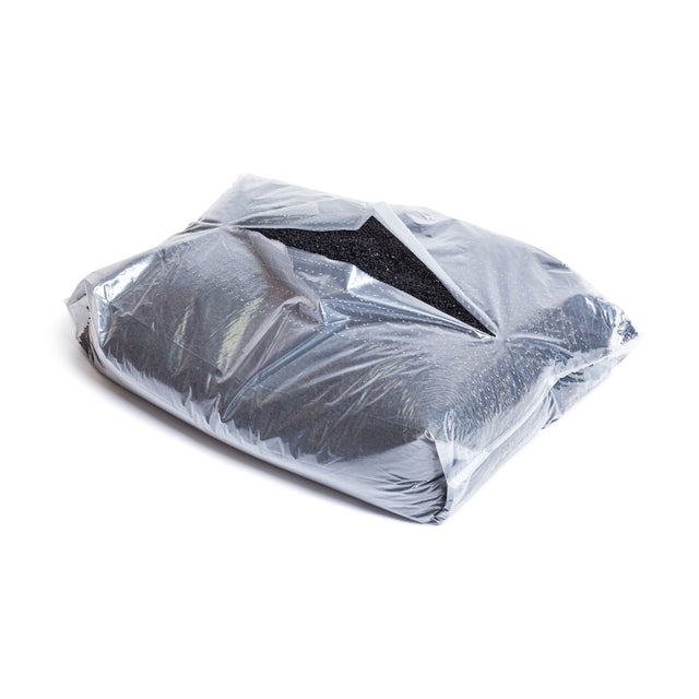 A partially open 40lb bag of Bells of Steel Recycled Tire Rubber Crumb Filler, containing black granular material made from recycled tires, sits on a white surface.