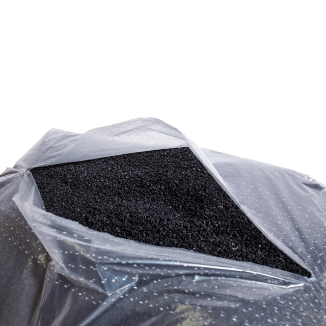 The Bells of Steel Recycled Tire Rubber Crumb Filler comes in a 40lb clear plastic bag with the top open, showing crumb rubber pellets made from recycled tires against a white background.