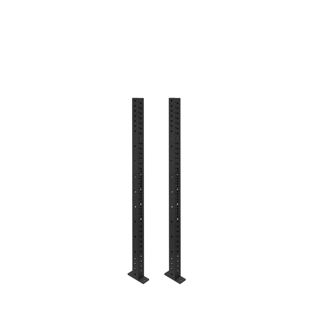 Two tall, black Hydra Vertical Uprights from Bells of Steel stand side by side on a plain white background, featuring evenly spaced holes to fit various power rack attachments.