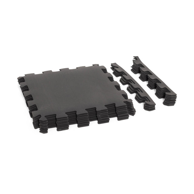 The Bells of Steel 24" x 24" Puzzle Mats (Set of 8) feature interlocking black tiles with matching borders, providing superior gym floor protection and shown on a white background.