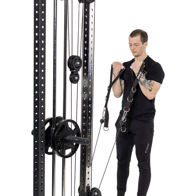 A man in black workout clothes uses Bells of Steel Aluminum Handles Pair to perform bicep curls on a cable machine against a white background.