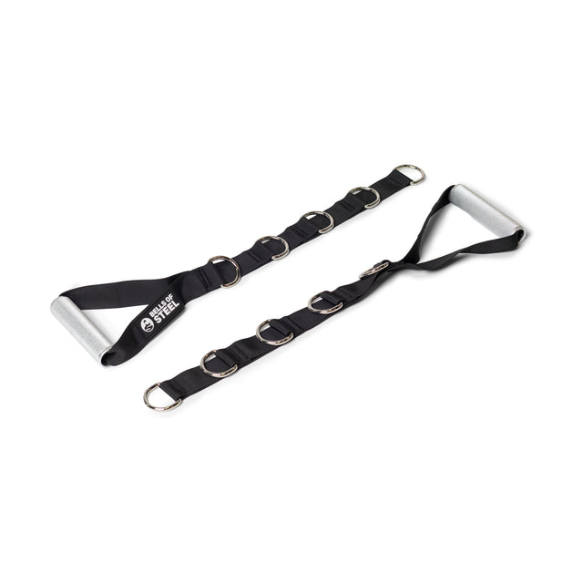 Two black adjustable straps with multiple metal D-rings and cushioned aluminum handles from Bells of Steel’s Aluminum Handles Pair, designed for exercise or cable machines, are laid out on a white background. One strap shows the "Sheer Steel" logo.