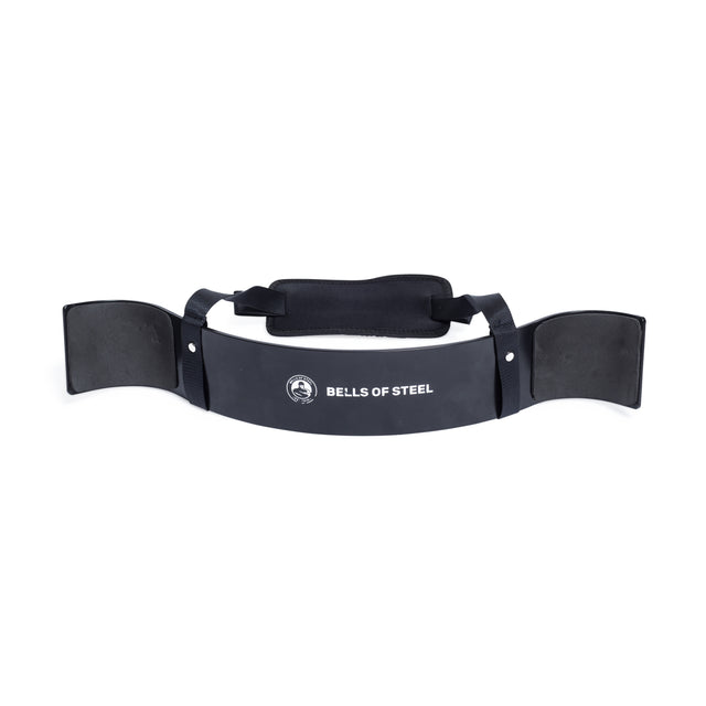 The Bells of Steel Arm Blaster is a stylish piece in black with a durable aluminum construction, displaying the brand's logo on its curved surface. Tailored for weightlifting, it comes equipped with padded elbow rests and an adjustable neck strap to help maintain proper form during strength training.