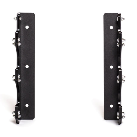 The Bells of Steel 3 Barbell Wall Rack features two black metal mounting brackets with bolts and circular holes, HDPE plastic lining for equipment protection, and provides upright, parallel storage for barbells.