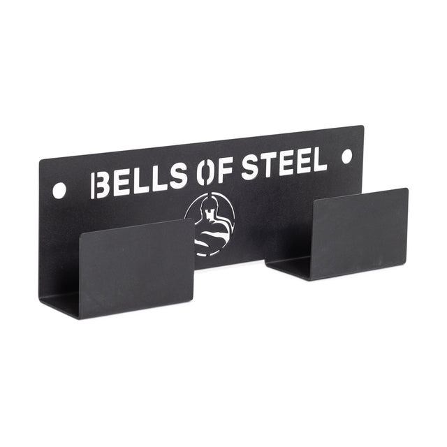 The Bells of Steel Wall or Rack Mounted Bench Hanger features a black metal design with logo, two angled slots, and offers organized storage as a weight bench wall mount for your gym or fitness equipment.