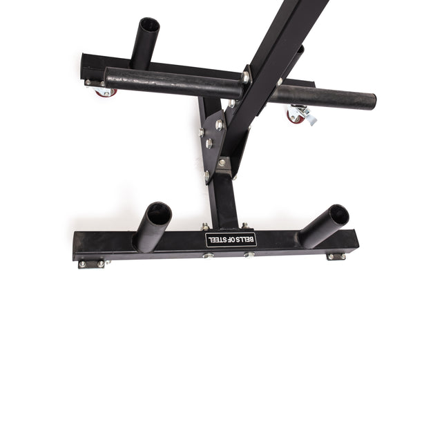 The Bells of Steel Bumper Plate Weight Tree and Bar Holder is a black metal sled with four vertical posts and wheels for efficient weight plate storage. Seen from above, the base is labeled "BELLS OF STEEL" on a white background.