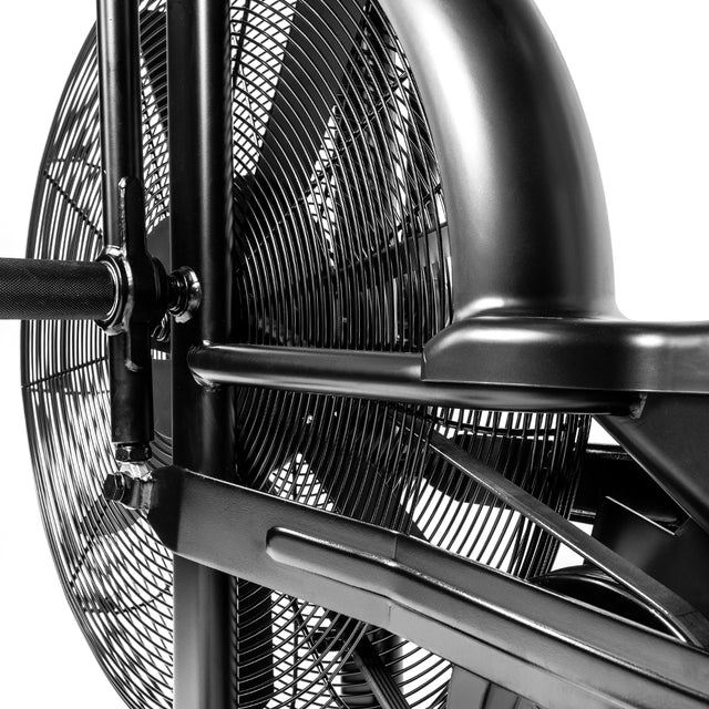 Close-up of the Blitz Air Bike by Bells of Steel, highlighting its large fan wheel, black metal frame, handlebar, detailed spokes, and protective grill—perfect for home gyms and full-body workouts.