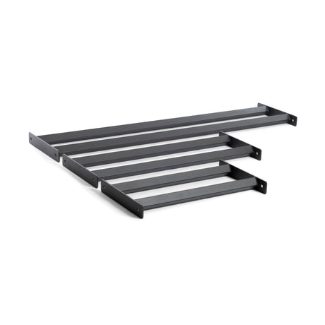 The Bumper Plate Pins Shelf by Bells of Steel features four black metal wall brackets, each with a simple rectangular shape and end holes for easy mounting, perfect for supporting shelves or similar fixtures to efficiently and stylishly organize your space.