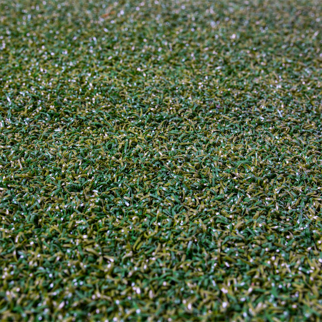 Close-up of Bells of Steel Roll of Gym Turf, featuring densely packed green and yellowish synthetic blades—perfect for sled training and intense workouts.