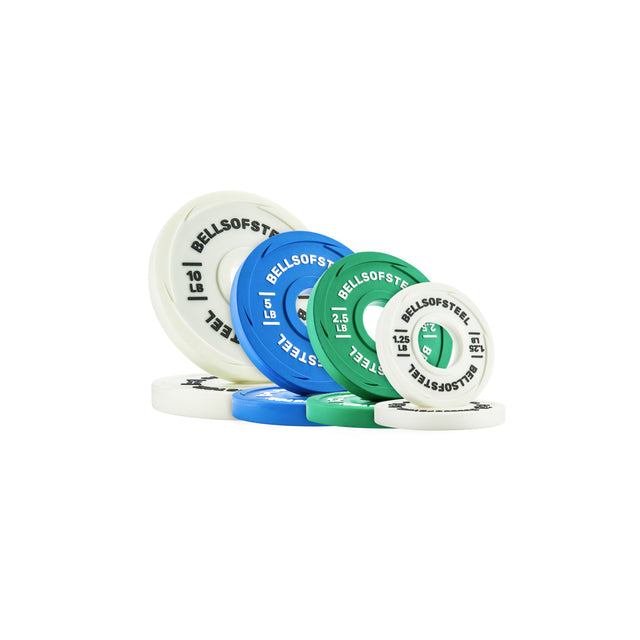 A set of Bells of Steel Urethane-Coated Change Plates in white, blue, and green, arranged on a white background—built with durability comparable to quality training plates.