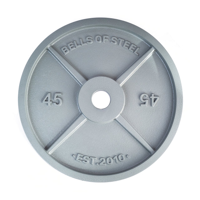 The Machined Iron Olympic Weight Plate by Bells of Steel is a gray, 45-pound iron plate with "Bells of Steel" and "EST. 2010" embossed on the front, featuring a precision-cut center hole for barbell compatibility.
