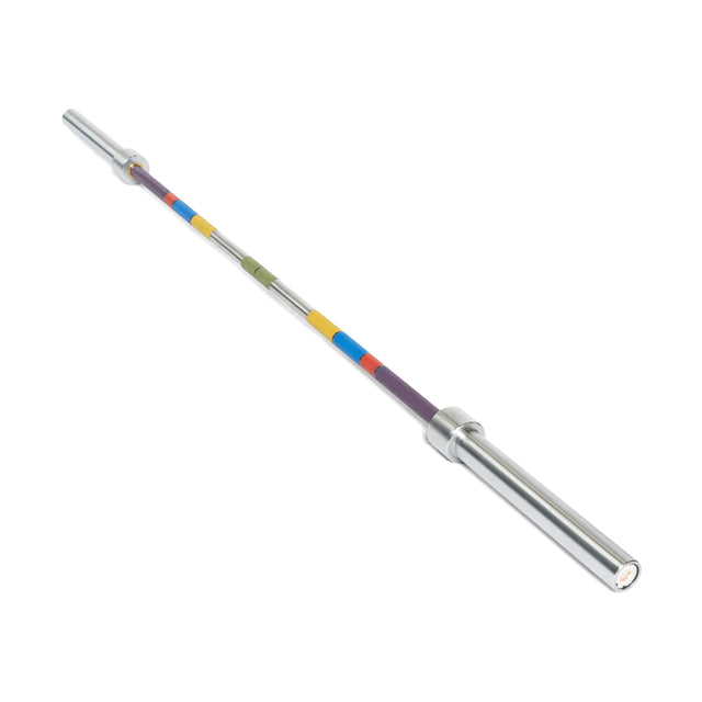 The Bells of Steel Hydra Seven Ring Bar is a silver weightlifting bar with aggressive knurling and a shaft featuring colored sections in yellow, red, blue, green, and purple, shown against a white background.