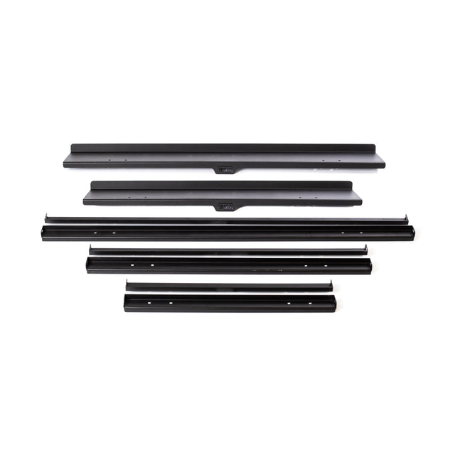 Image of several black metal brackets of varying lengths arranged horizontally on a white background. Perfect for assembling or installing the Bells of Steel Commercial Interchangeable Weight Rack - Components Only, these brackets feature multiple holes for screws or bolts to accommodate versatile storage solutions.