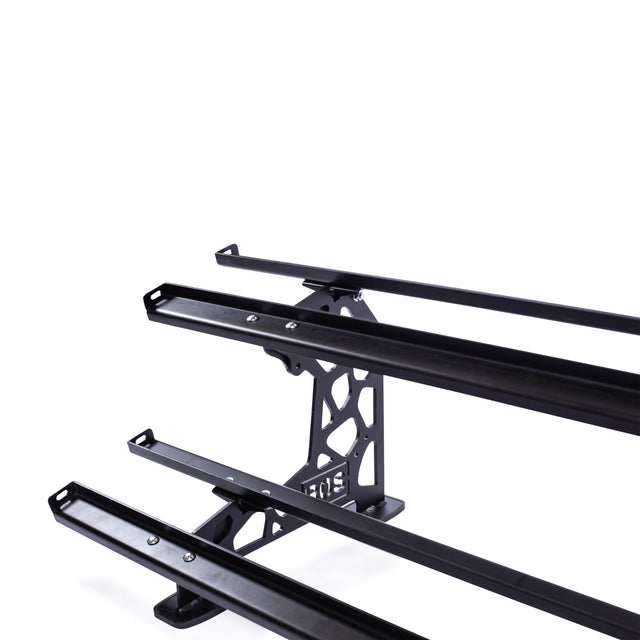 A Commercial Interchangeable Weight Rack - Components Only by Bells of Steel is displayed on a white background, showcasing a modern geometric design. With its multiple parallel bars and robust frame, it provides versatile functionality—perfect for carrying cargo or accommodating swappable storage shelves on the top of a vehicle.