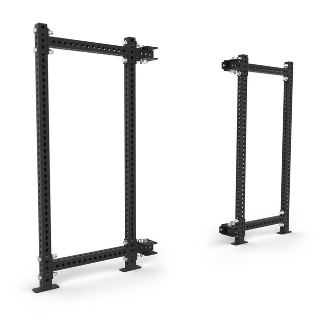 Two Bells of Steel Manticore Folding Power Rack Builder units (3" x 3", 1" holes) are shown on a white background—one from the front, one at an angle—ideal for any home gym.