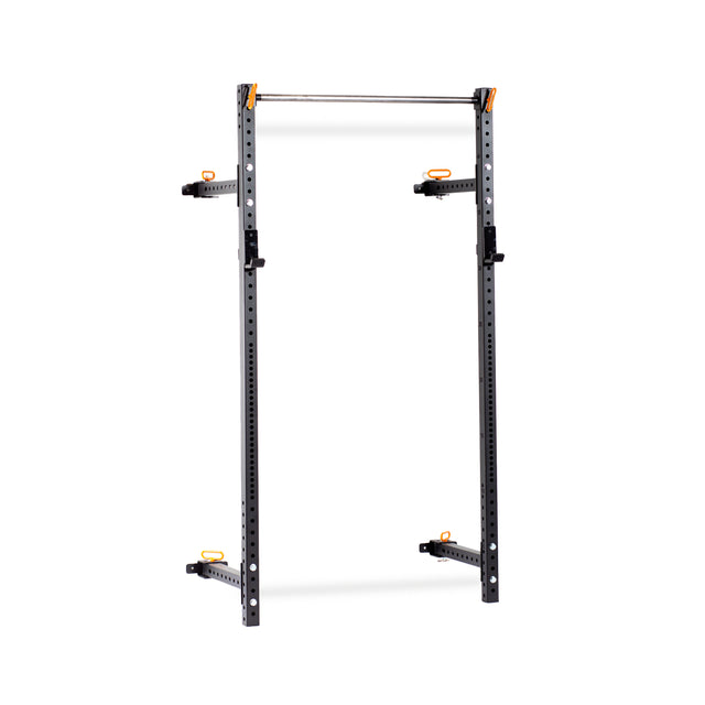 The Bells of Steel Folding Rack 2.3" x 2.3" (5/8" Holes) is a freestanding metal squat rack with a 600-lb weight capacity, adjustable J-hooks, safety arms, pull-up bar, and bold black posts with orange accents—perfect for any garage gym.