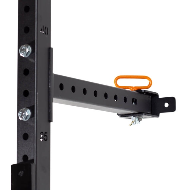 A close-up of the Bells of Steel Folding Rack 2.3" x 2.3" (5/8" Holes) attachment, secured to an upright with numbered holes, bolts, and an orange safety pin—ideal for your garage gym or a wall-mounted folding squat rack with pull-up bar compatibility.
