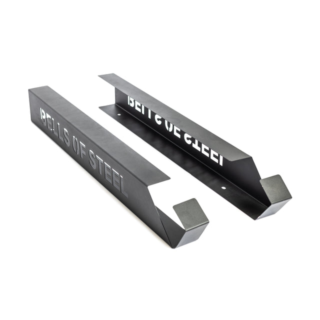 Two black metal brackets with angled ends and "Bells of Steel" cutouts, designed as a wall-mounted Foam Roller Storage organizer, displayed on a white background.