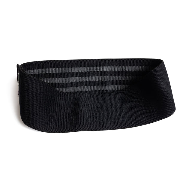 The Bells of Steel Glute Loop is a wide, black elastic resistance band featuring inner horizontal stripes for a non-slip grip, displayed against a white background.