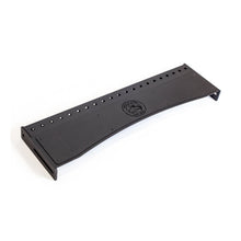 A black, rectangular Bells of Steel Logo Plate Crossmember metal panel with a center logo and multiple top holes, designed for Manticore Rack compatibility, displayed against a white background.
