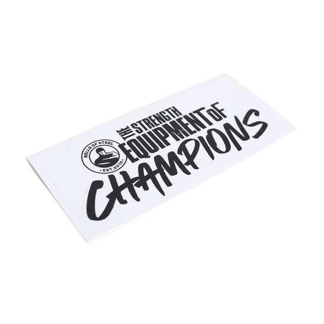 A durable white die-cut Bells of Steel sticker features bold black text, “The Strength Equipment of Champions,” and a circular logo on the left reading “Island of Steel EST. 2021.”.
