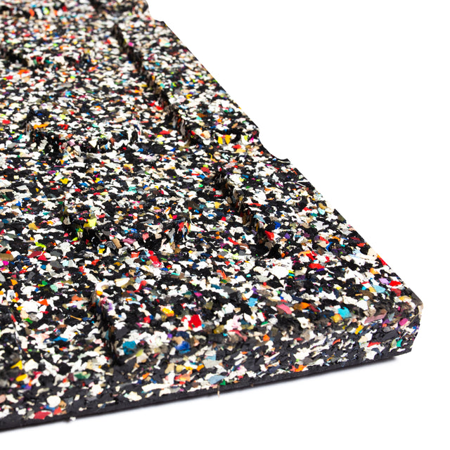 Close-up of the Bells of Steel Rubber Flooring Gym Mat 39" x 39" with a speckled, textured surface in black, white, red, yellow, blue, and green—made from recycled materials for excellent sound dampening.