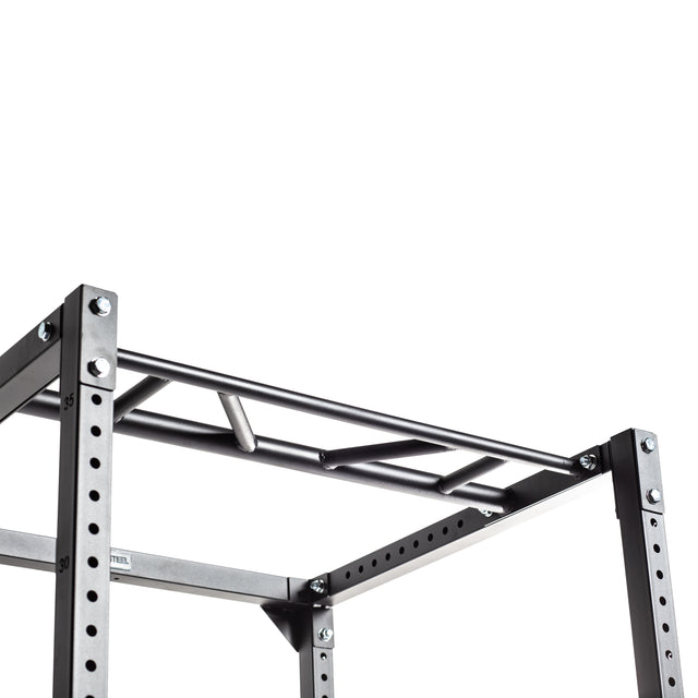 A close-up of the Bells of Steel Light Commercial Power Rack (2.3" x 2.3", ⅝" holes) shows its multi-grip pull-up bar and numbered holes for adjustable attachments, ensuring barbell safety in any home gym against a white background.