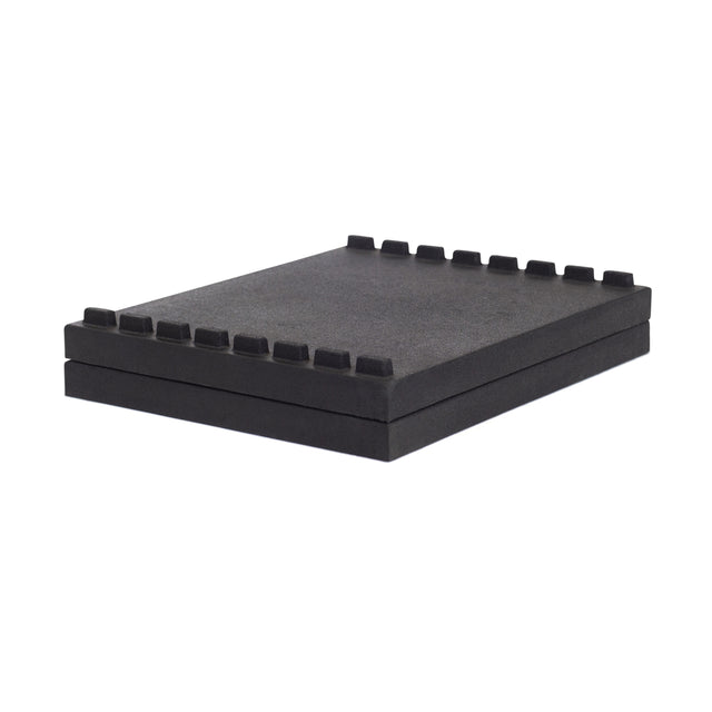 The Bells of Steel Stackable Pull Blocks are black rectangular foam pads with evenly spaced raised notches along one edge, designed to be stacked for space-efficient lifting in your gym setup.
