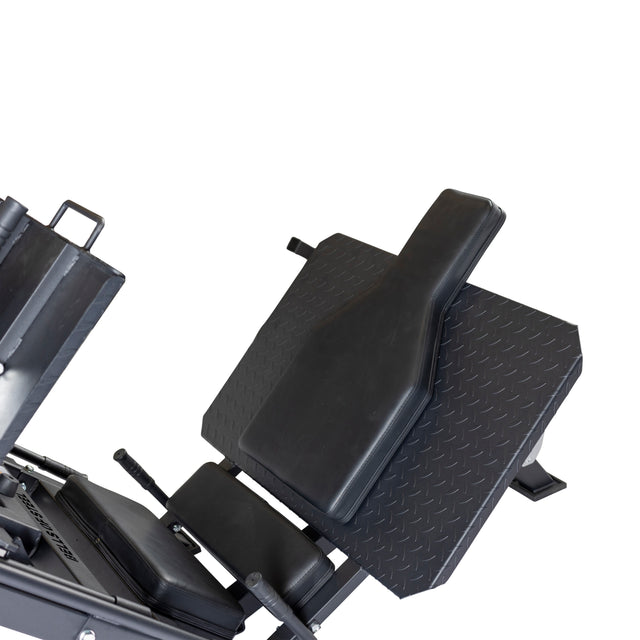 Introducing the Bells of Steel 2-in-1 Iso Leg Press & Hack Squat Machine, also known as The Juggernaut. This black machine is ideal for leg presses, hack squats, and calf raises, featuring a padded seat and foot platform crafted specifically for lower body workouts. The product is showcased on a white background.
