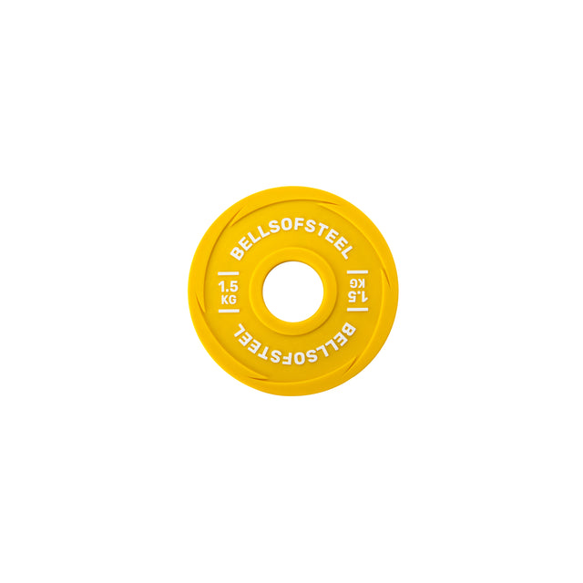 A yellow Bells of Steel Urethane-Coated Change Plate with "1.5 KG" in white text is pictured from above on a white background—ideal for making precise adjustments to your training plates.