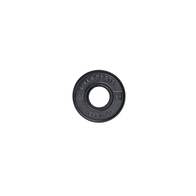 This black 2.5 kg "Bells of Steel" calibrated powerlifting plate boasts a central hole for barbell mounting. The circular metal design, inscribed with "EST. 2010," ensures consistent performance with standardized diameters.