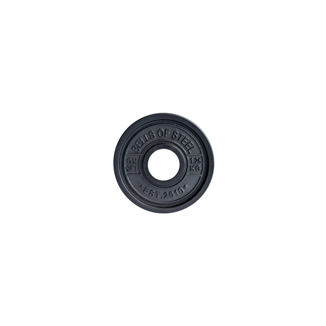 A black circular "Calibrated Powerlifting Plates - KG" by Bells of Steel, marked with "1.25 KG" and "EST. 2010," features standardized diameters and a barbell hole, set against a plain white background.
