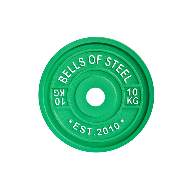 The green "BELLS OF STEEL" Calibrated Powerlifting Plate, marked "10 KG" and "EST. 2010," includes a central barbell-mounting hole and is colour-coded for precision. Crafted with standardized diameters, it ensures optimal performance.