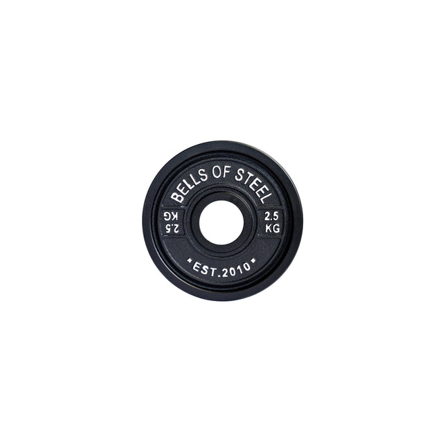 A black Calibrated Powerlifting Plate from Bells of Steel, marked "2.5 KG" and "EST. 2010," complies with standardized diameters.
