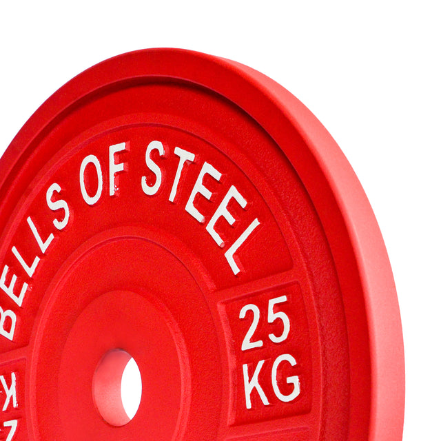 Close-up of a red 25 KG Calibrated Powerlifting Plate by Bells of Steel, designed to IPF specs with "Bells of Steel" and "25 KG" in white. It features a smooth circular design and central hole for barbell attachment.