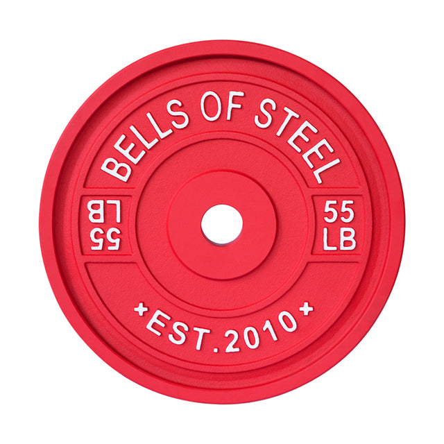 A red, color-coded "BELLS OF STEEL" calibrated powerlifting plate displays "55 LB" on both sides and "EST. 2010" at the bottom, featuring a central hole for seamless barbell loading.