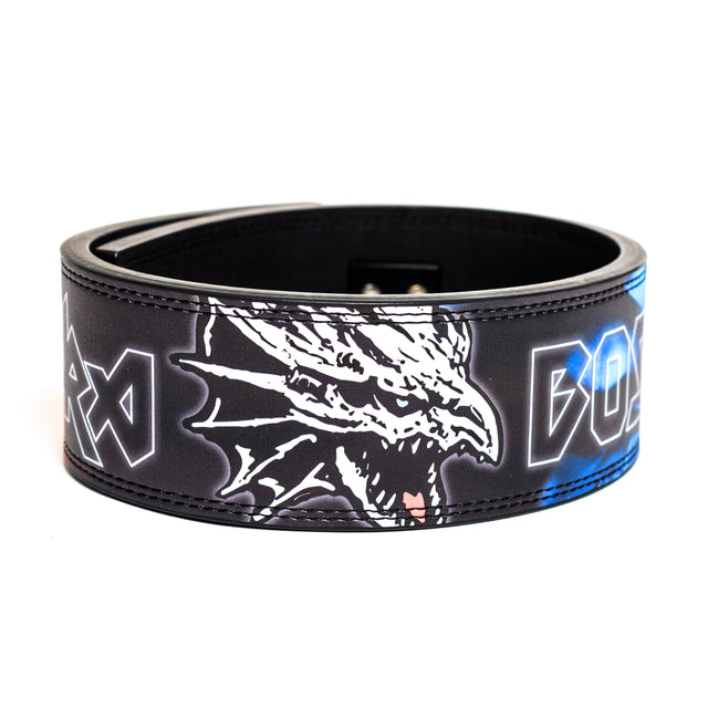 The Bells of Steel Lever Belt is a black leather lifting belt with a white roaring dragon head graphic and bold blue and white angular textâideal for powerlifting sessions.