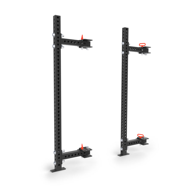 The Bells of Steel Manticore Folding Half Rack (3" x 3", 1" Holes) features two black vertical stands with red locking pins and base plates—perfect for customizing your home gym rack setup.