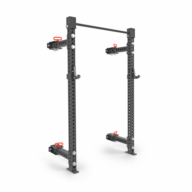 The Bells of Steel Manticore Folding Half Rack—3"x3" uprights with 1" holes, four red-handled safety arms, and a top pull-up bar—is a modular black power rack ideal for any home gym.