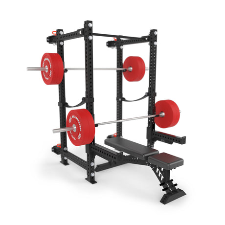 The Bells of Steel Manticore Folding Power Rack - Prebuilt (3" x 3", 1" holes), shown in black with a bench, barbells, and red plates, is ideal for weightlifting exercises like bench press and squats—perfect for any home gym.