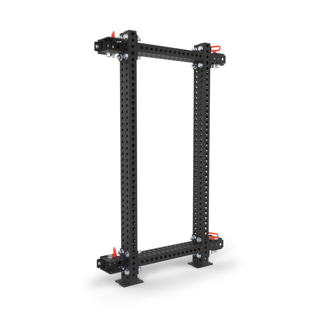 The Bells of Steel Manticore Folding Power Rack - Prebuilt (3"x3", 1" holes) is a black metal rack with red handles, bolt-secured corners, and flat feet—perfect for a home gym setup.